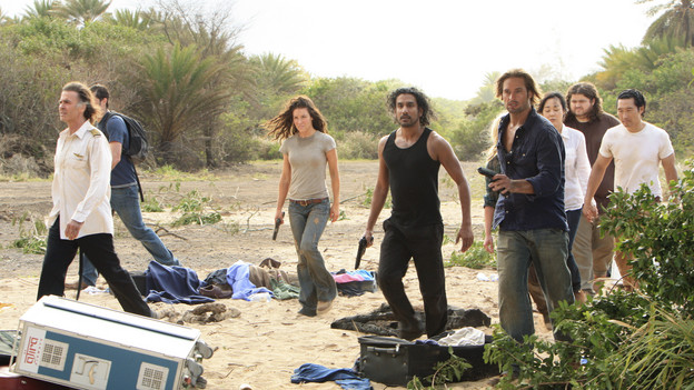 The cast of LOST walks on the beach.