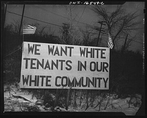 A white sign with two flags on it that was posted in Detroit Michigan during the battle over the Sorjourner Truth Homes. The sign says: We want White Tenants in our White Community"