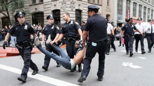 Occupy Wall St protestor being dragged away by four NYPD officers