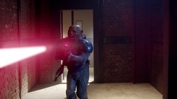 A Sontaran warrior fires an energy weapon while running