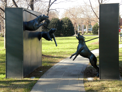 A sculpture of snarling police dogs leaping out at visitors from two walls