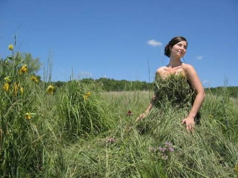 Woman posing in a field in a dress made of grass clippings