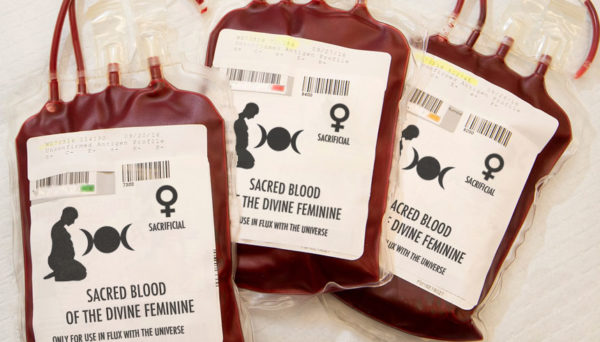 Three blood bags, with female/moon goddess symbols on them, labeled "Sacred Blood of the Divine Feminine - Only for Use in Flux with the Universe"