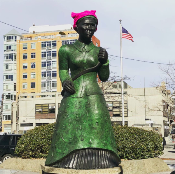 "Swing Low" statue of Harriet Tubman in Harlem, with a pink knitted Pussyhat on her head