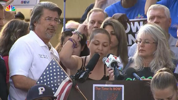 Stoneman Douglas High School senior Emma Gonzalez, surrounded by classmates and supporters, stands at a podium at a press conference to speak out against gun violence and claims that it can't be prevented